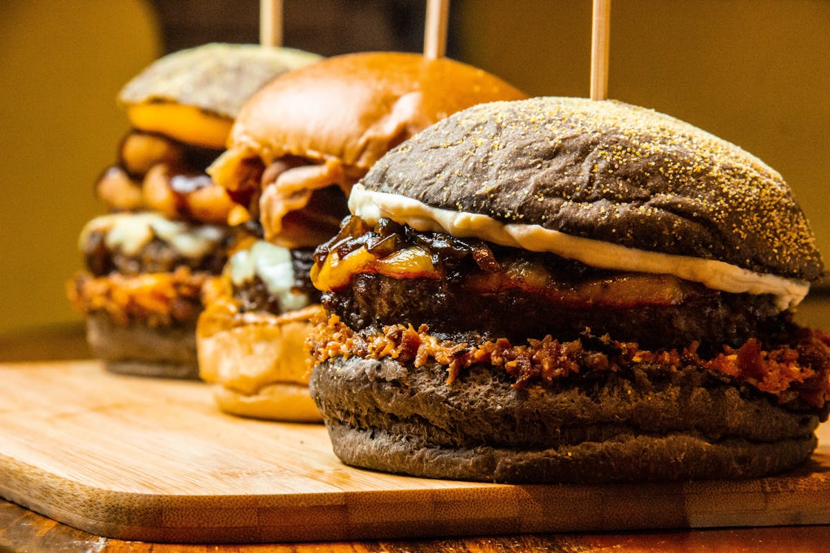 Gourmet burgers on wooden board